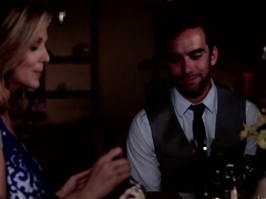 A blonde is having a romantic dinner with her lover in the dark