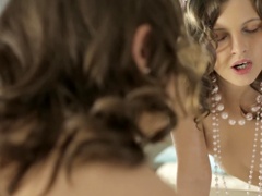 A brunette with pointy nipples pulls on a rubber cock in the video