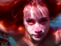 Sensational redhead babe in the warm deep blue sea