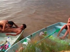Horny people are having group sex on the beach in a small boat