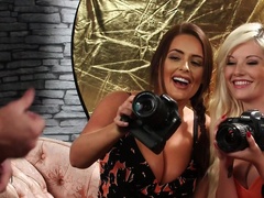 Photographers Emily Jade and Emma C. watch a model stroke his stiff wood